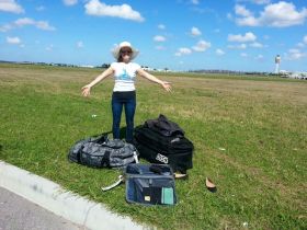 Kristin Wilson with luggage on the ground near the airport – Best Places In The World To Retire – International Living